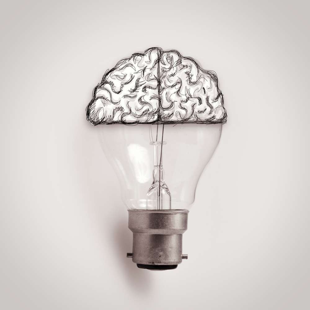 Light bulb with hand drawn brain as creative idea concept