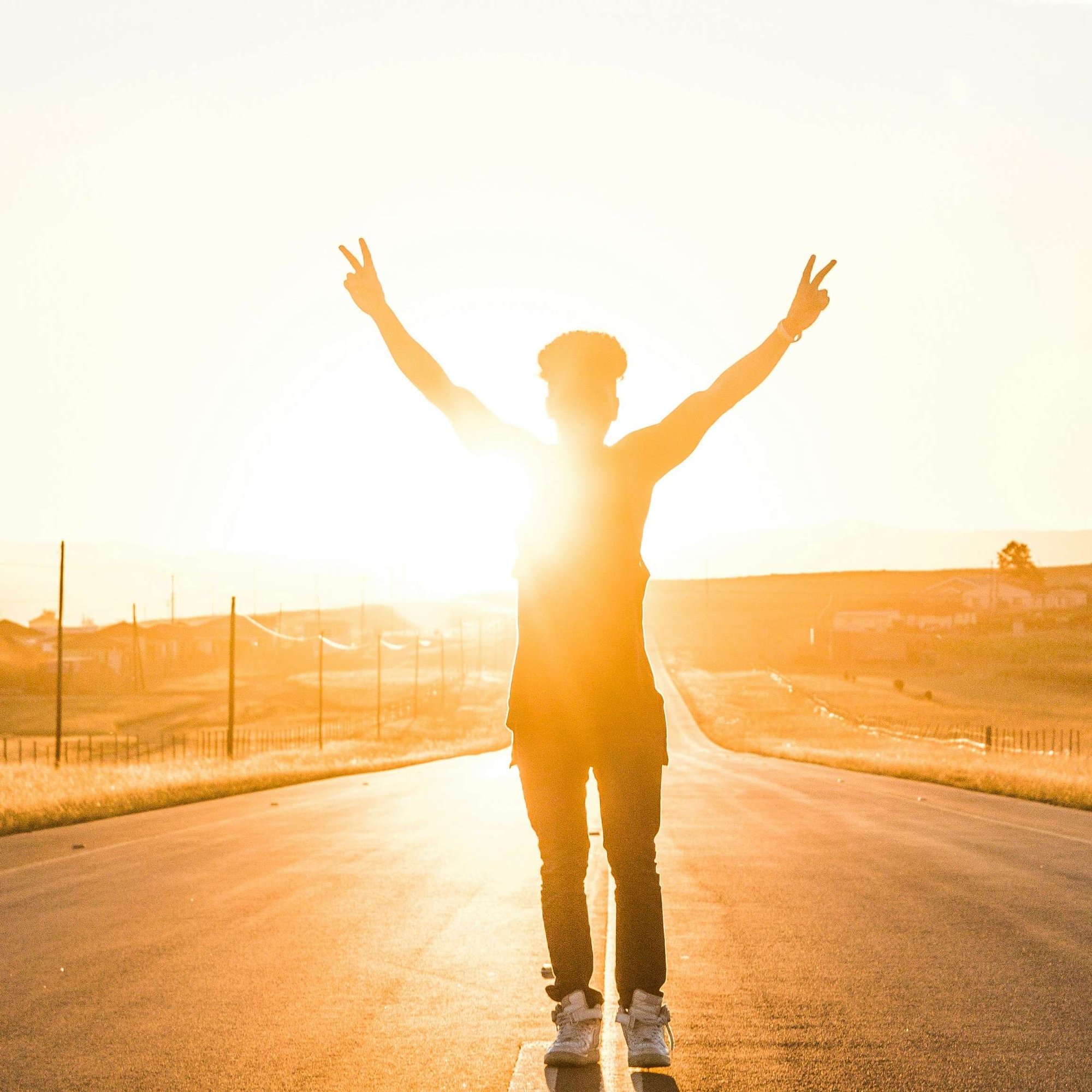 Woman holding arms up in success