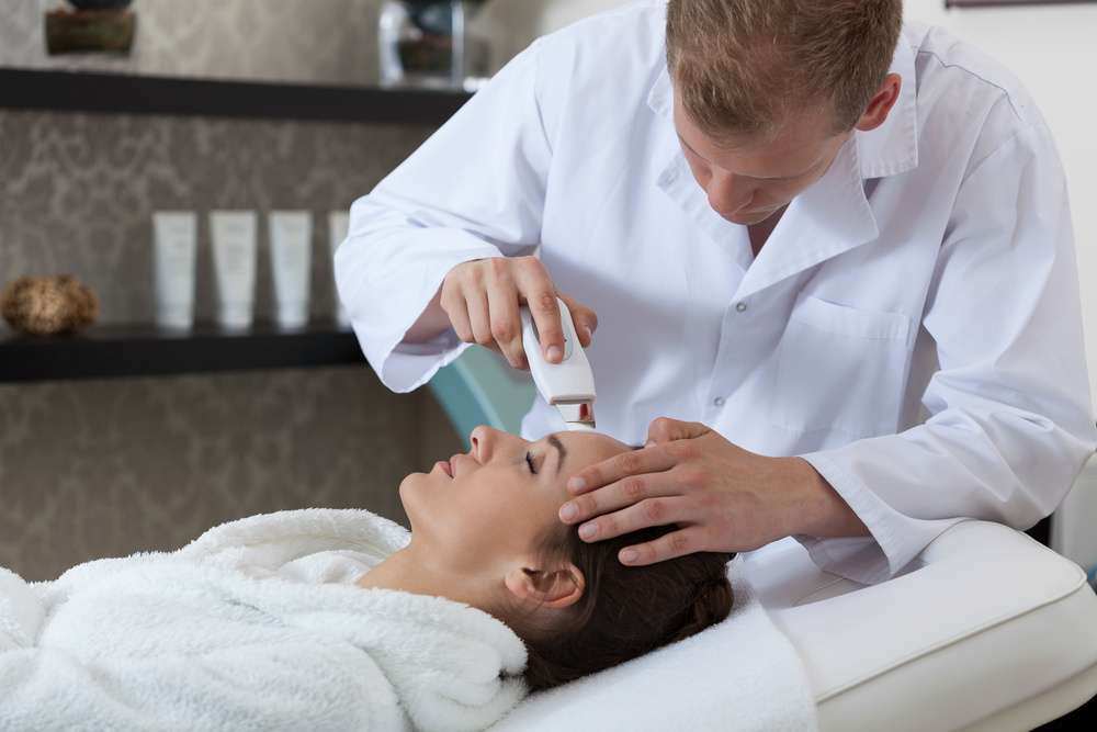 Lady having cavitation peeling in spa room